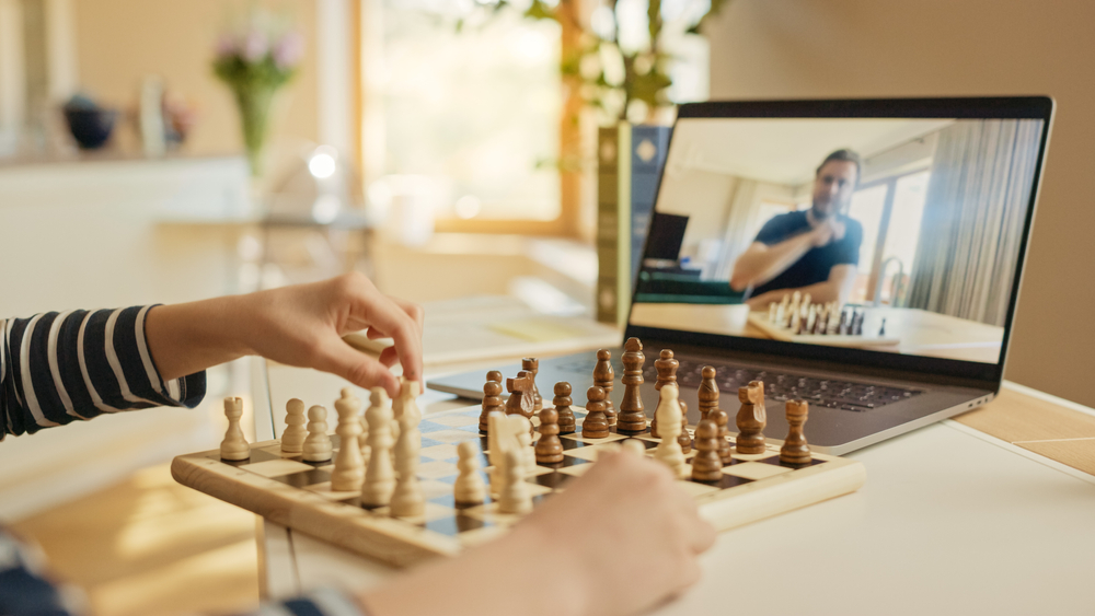 man teaching chess online