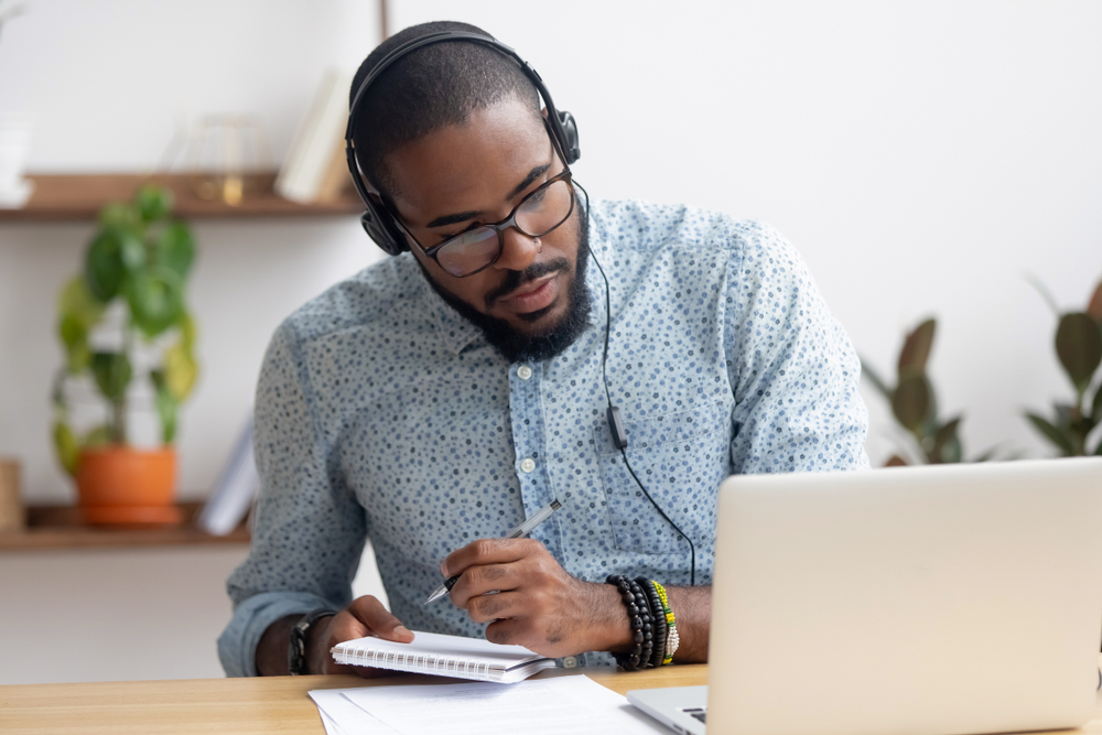 man with headphones doing an online course